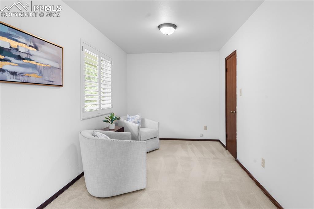 Image 19 of 44: Primary bedroom sitting area (walk in closet to right)