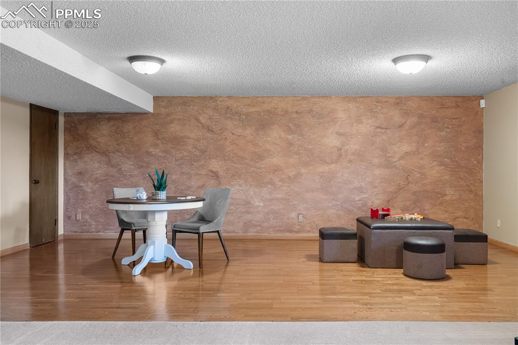 Image 29 of 44: Recreation room has large wood floor at one end
