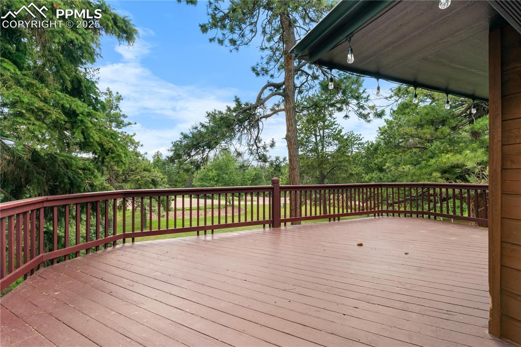 Image 33 of 44: Huge deck overlooking side/front yard