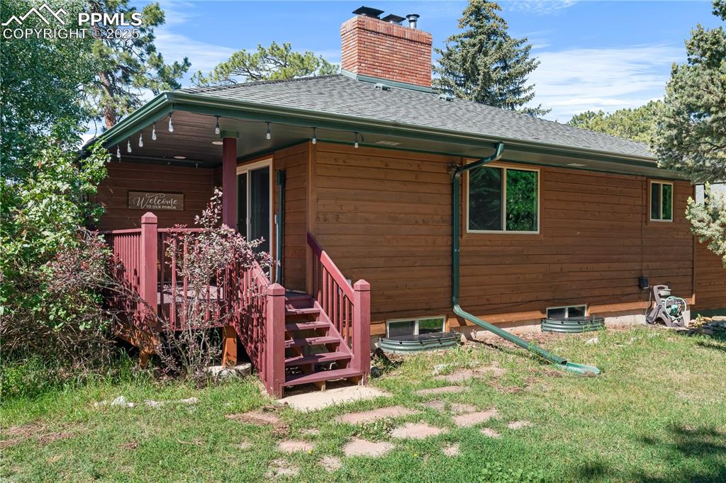 Image 34 of 44: Second small deck on back side of house off family room.
