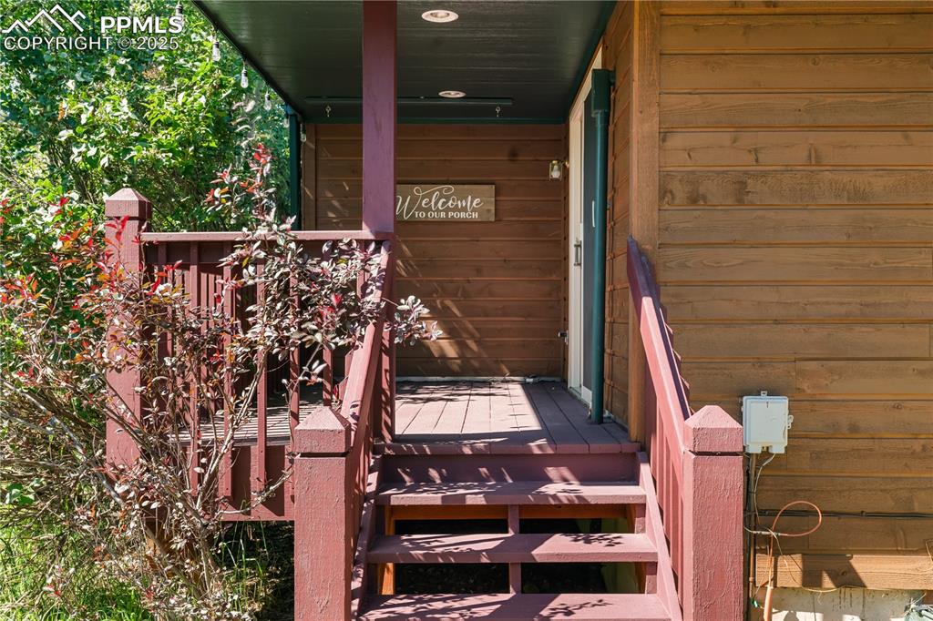 Image 35 of 44: Second small deck on back side of house off family room.