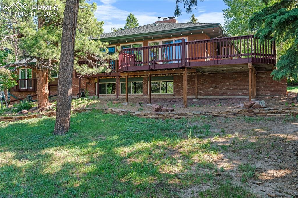 Image 40 of 44: This beautiful home is surrounded by mature trees with a large side/corner