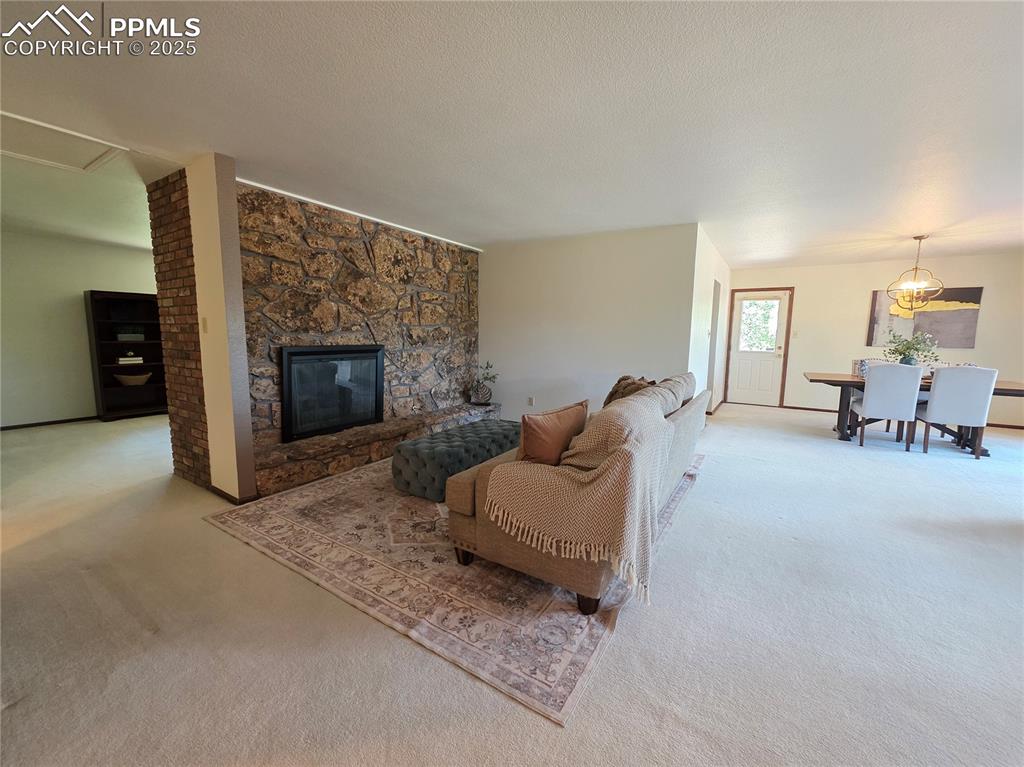 Image 8 of 44: Gas fireplace with rock wall in living room