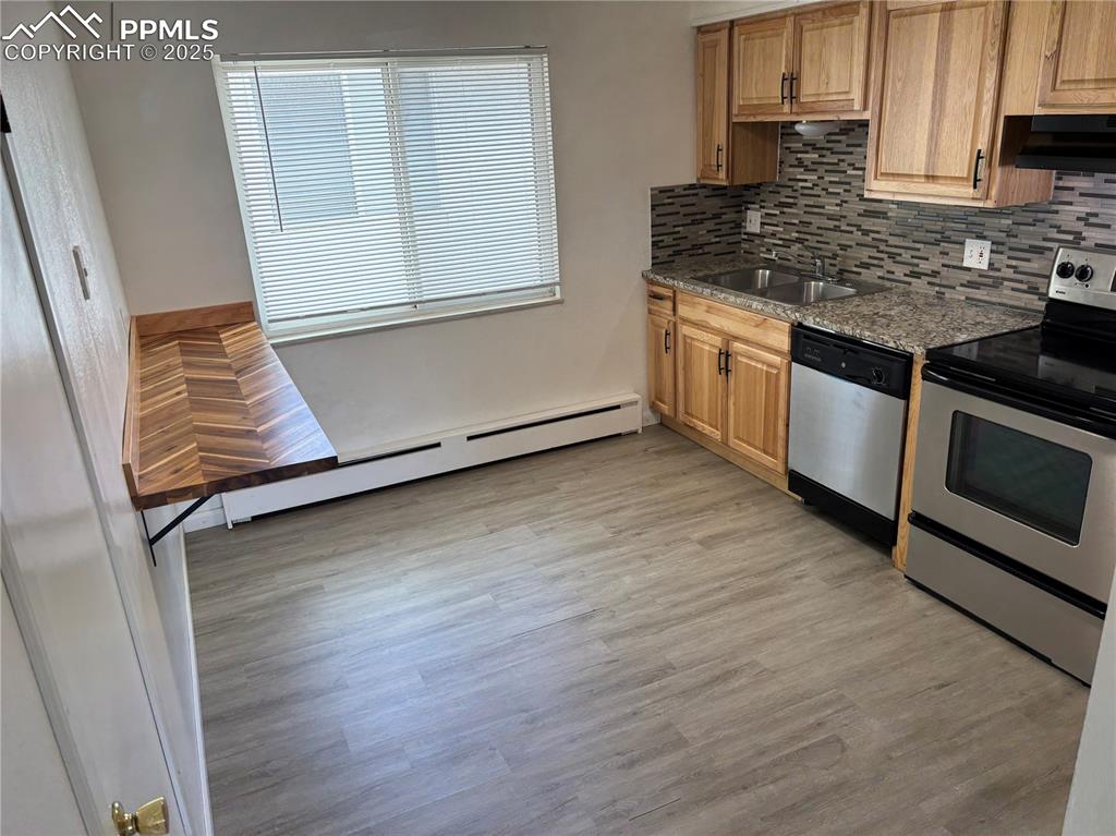 Image 38 of 42: Unit 3 - Kitchen featuring stainless steel appliances, tasteful backsplash,