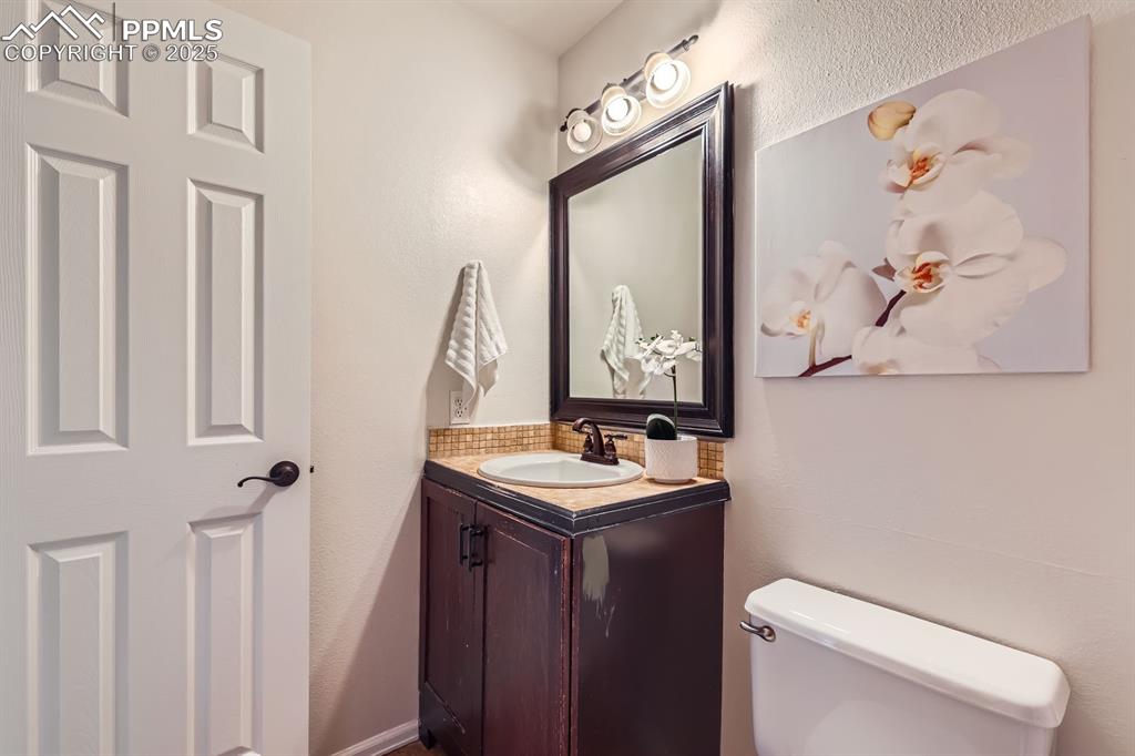 Image 18 of 28: Bathroom with vanity and a textured wall