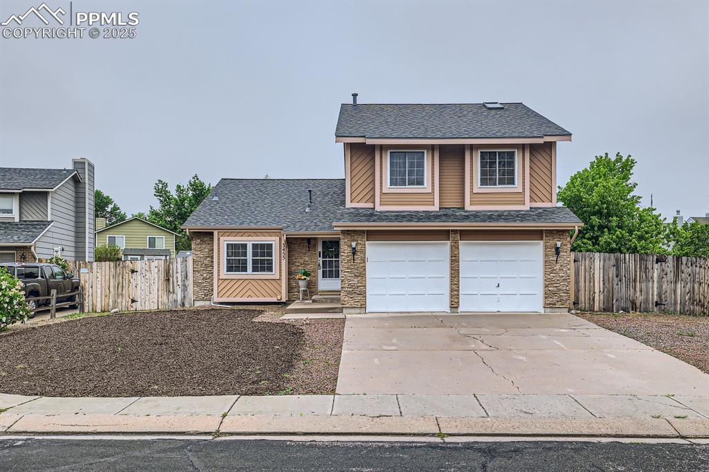 Image 2 of 28: View of front of home featuring a shingled roof, concrete driveway, and an