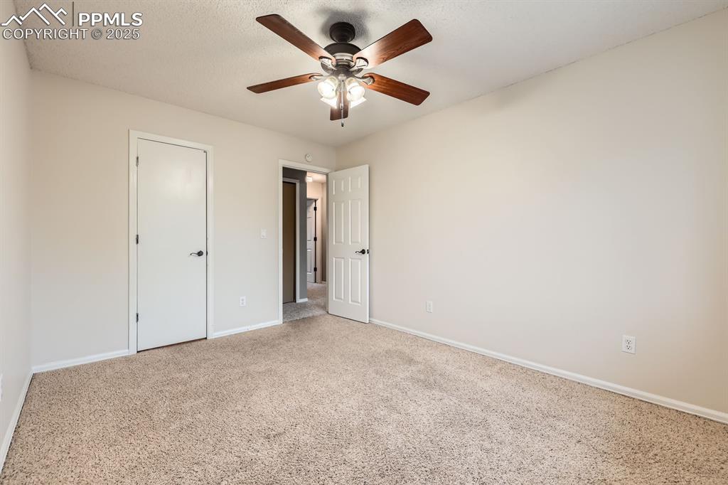 Image 20 of 28: Unfurnished bedroom with carpet flooring, a textured ceiling, and a ceiling
