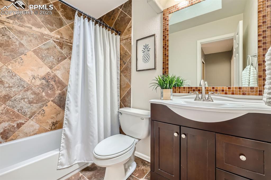 Image 22 of 28: Bathroom with vanity and shower / tub combo