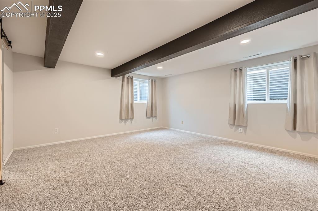 Image 23 of 28: Below grade area featuring recessed lighting and carpet floors