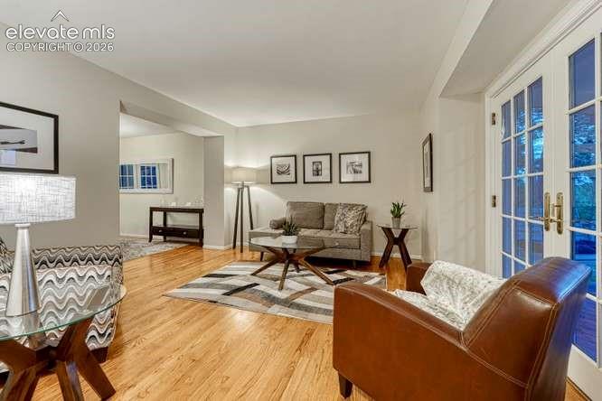 Image 21 of 49: Living room on main with walk out to covered 
front porch
