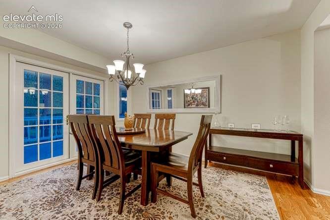 Image 22 of 49: Formal dining room with walk out to expanded deck
