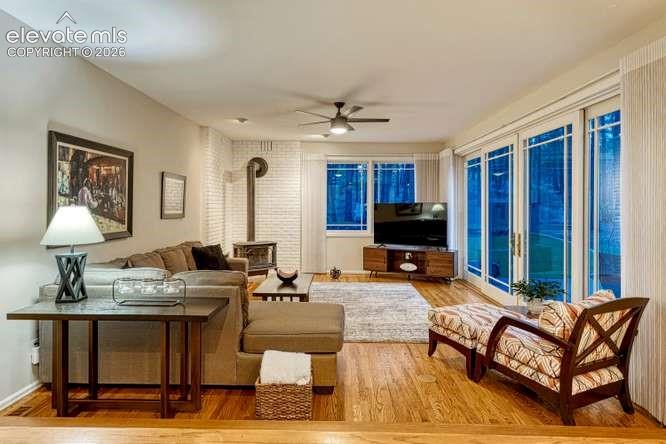 Image 23 of 49: Family room off kitchen with cozy gas stove and bi-parting sliding glass do