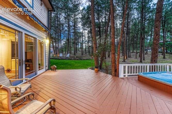 Image 38 of 49: deck with built in 8 person hot tub, retractable awning