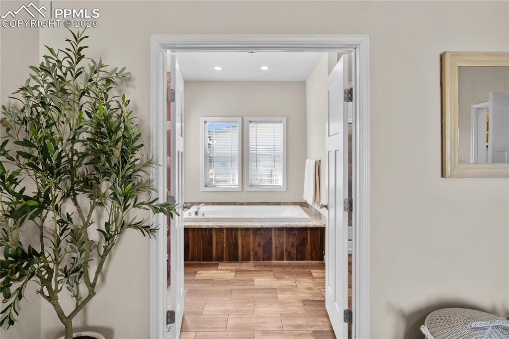 Image 16 of 31: french doors, primary 5 piece bathroom attached to primary bedroom