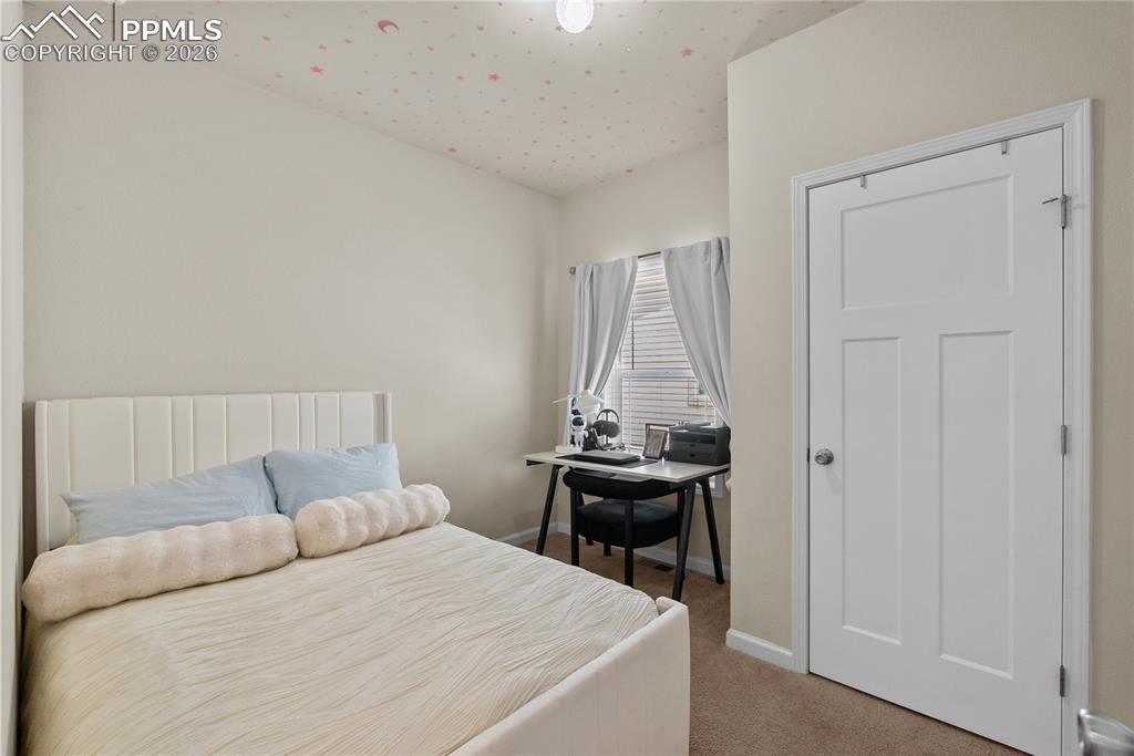 Image 9 of 31: bedroom, main living, across from the kitchen 