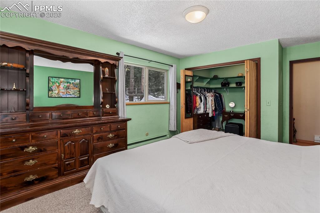 Image 21 of 50: Main level primary bedroom.