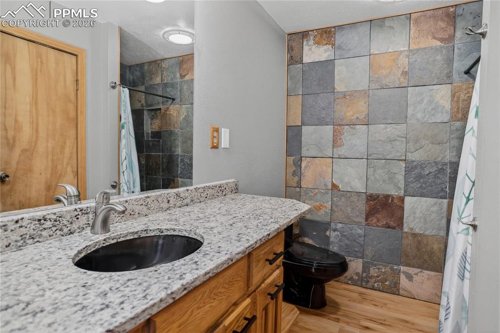 Image 24 of 50: Main level 3/4 hall bath.