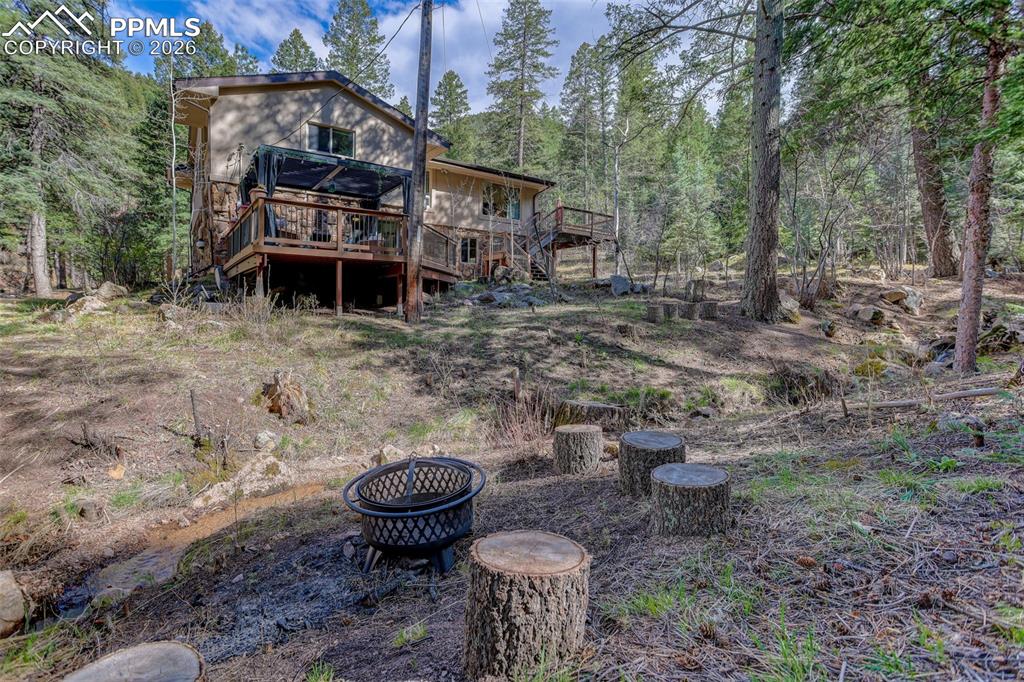 Image 36 of 50: East side of the house and view of lower level deck.