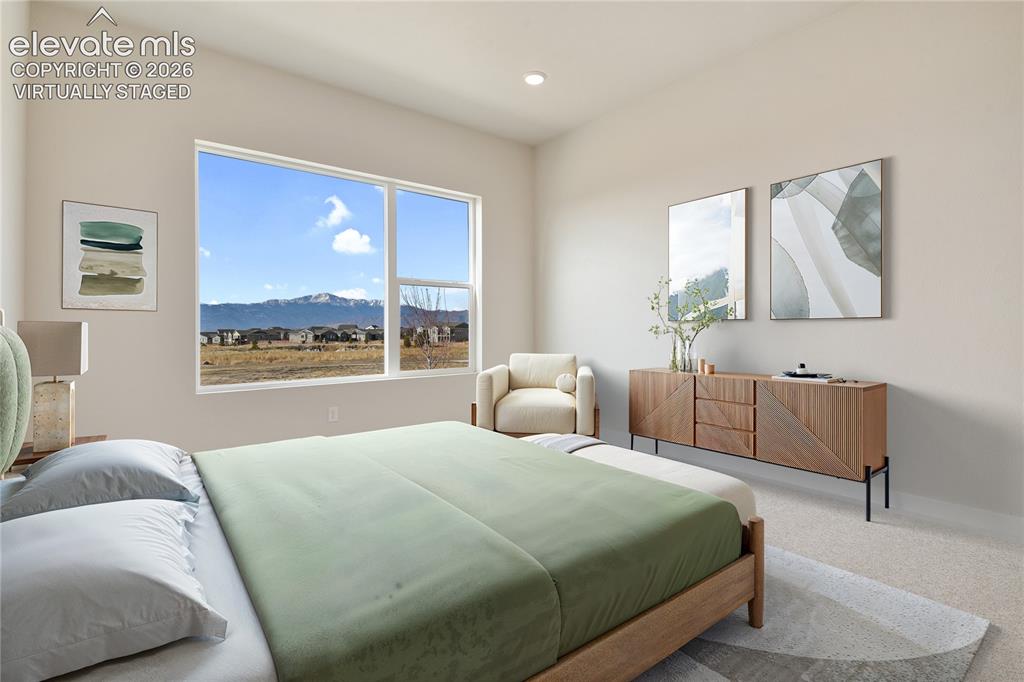 Image 10 of 50: Unobstructed Pikes Peak Views from the primary bedroom. Virtually Staged