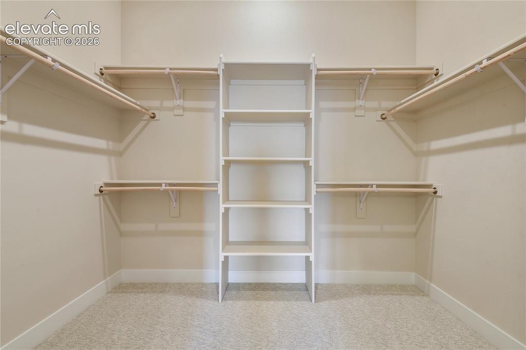 Image 15 of 50: Oversized walk-in closet in primary suite
