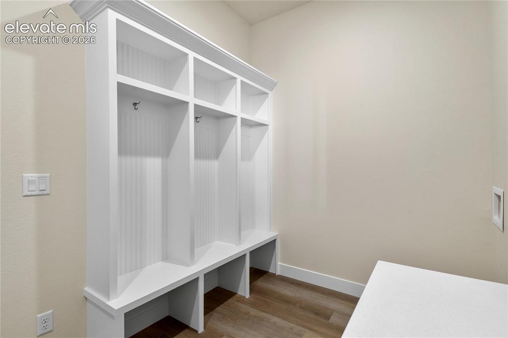 Image 18 of 50: Mud room/laundry area features custom built-in cubbies and convenient acces