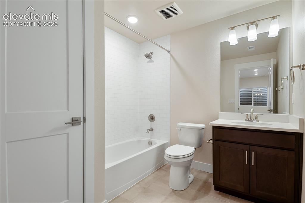 Image 23 of 50: Full bath in basement with linent closet