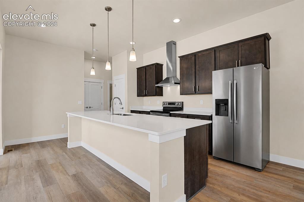 Image 6 of 50: Kitchen offers a large center island, quartz counters, stainless appliances