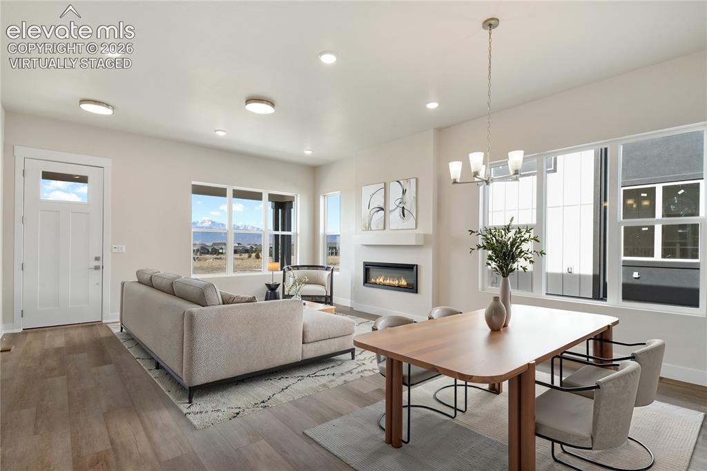 Image 8 of 50: Another view of the great room with amazing mountain views. Virtually Stage