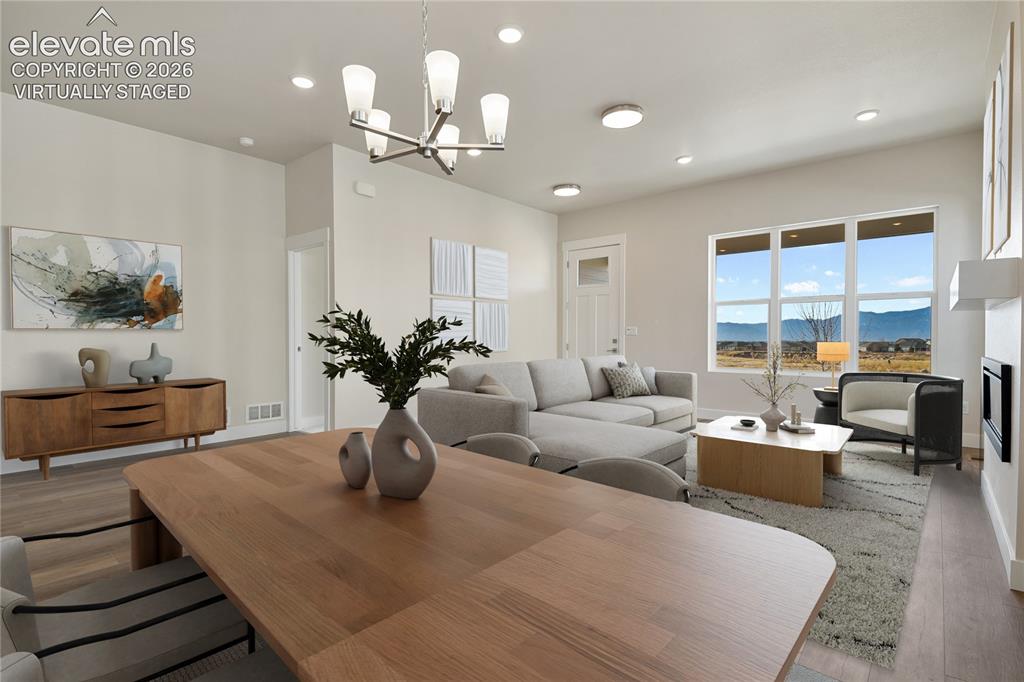 Image 9 of 50: Generous dining area open to both living room and kitchen Virtually Staged