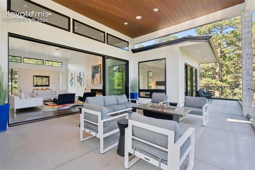 Image 7 of 50: A private outdoor retreat framed by towering pines and the beauty of Colora