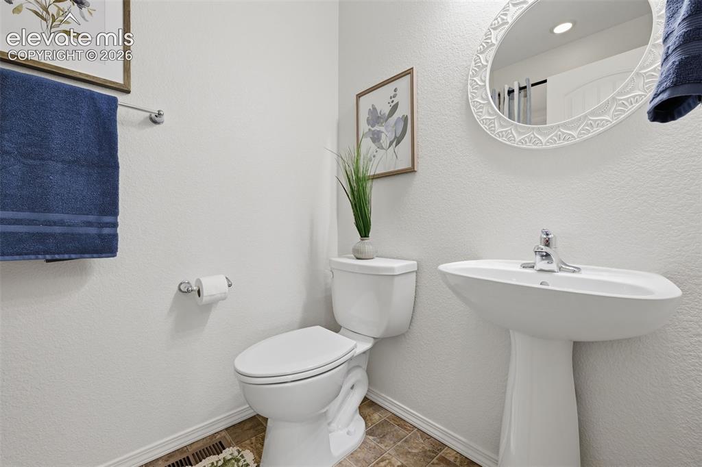Image 10 of 37: Full bathroom on main level for guests 