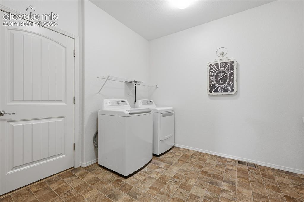 Image 11 of 37: HUGE! Main level Laundry room area entry from garage into the home, can als