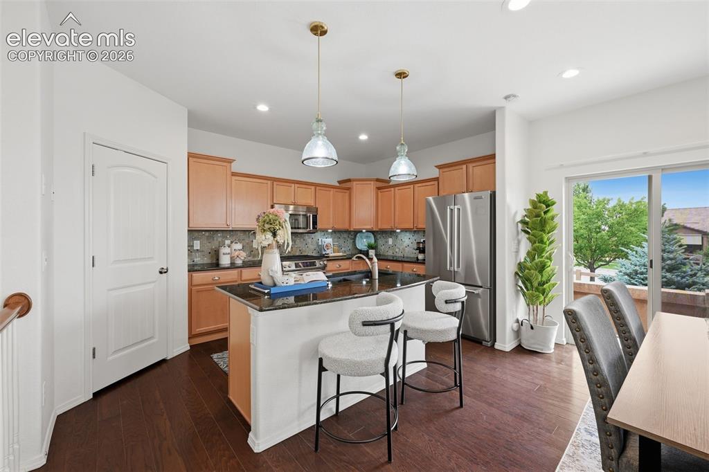 Image 15 of 37: View towards sliding doors to side patio with grill and space for an outdoo