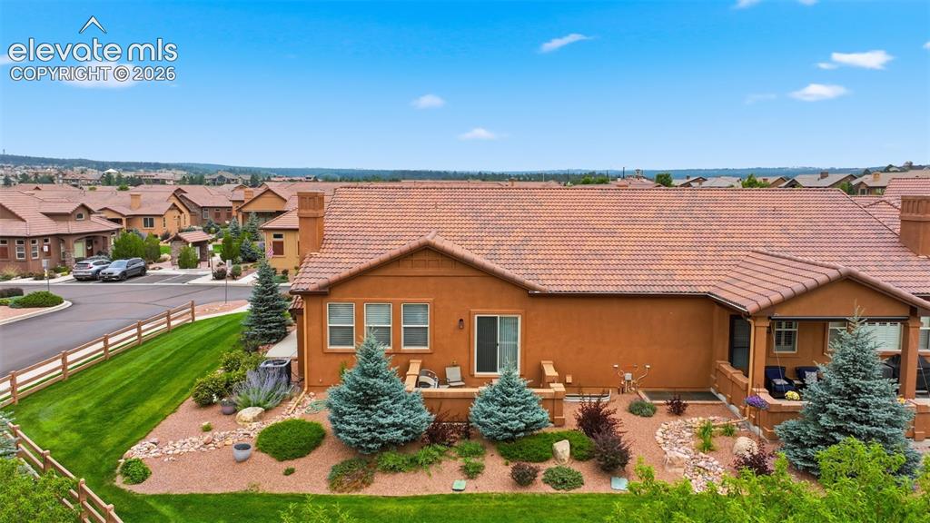 Image 17 of 37: View of side patio and the gorgeous landscaping that is handled by the HOA 