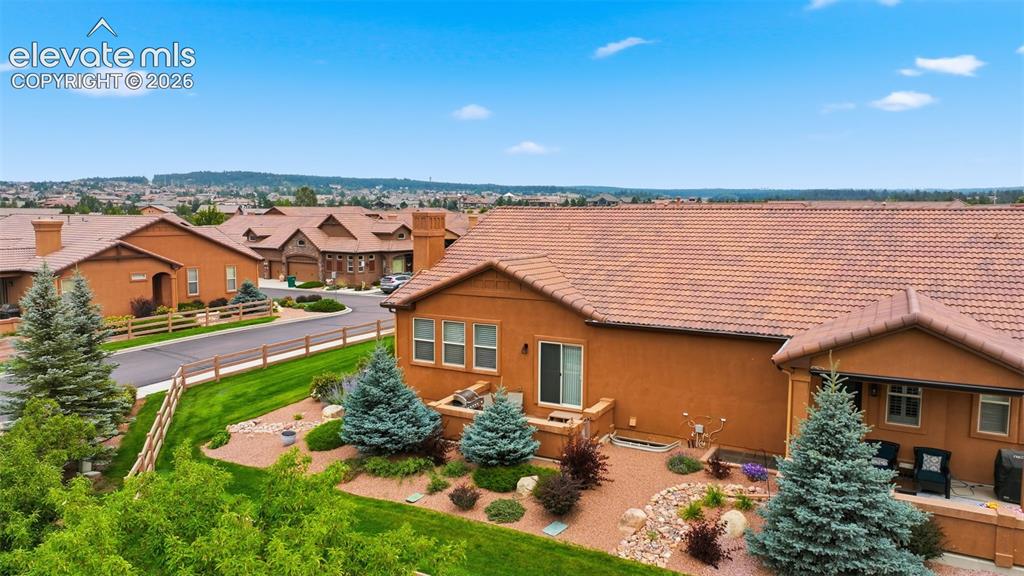 Image 18 of 37: View of side patio and the beautiful landscaping the HOA handles for you.