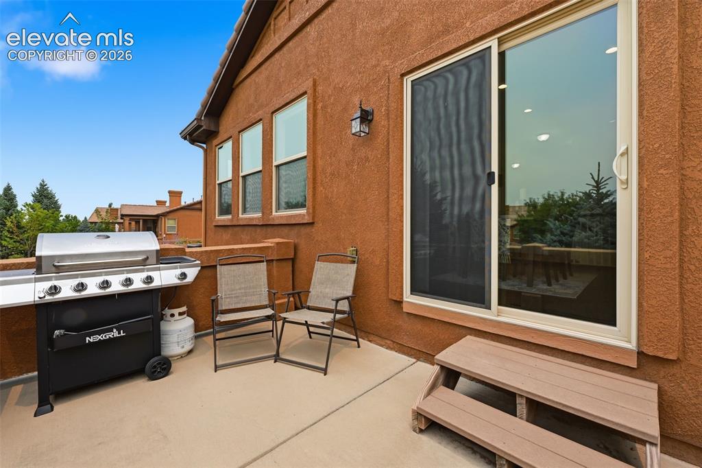 Image 19 of 37: Side patio view with grill
