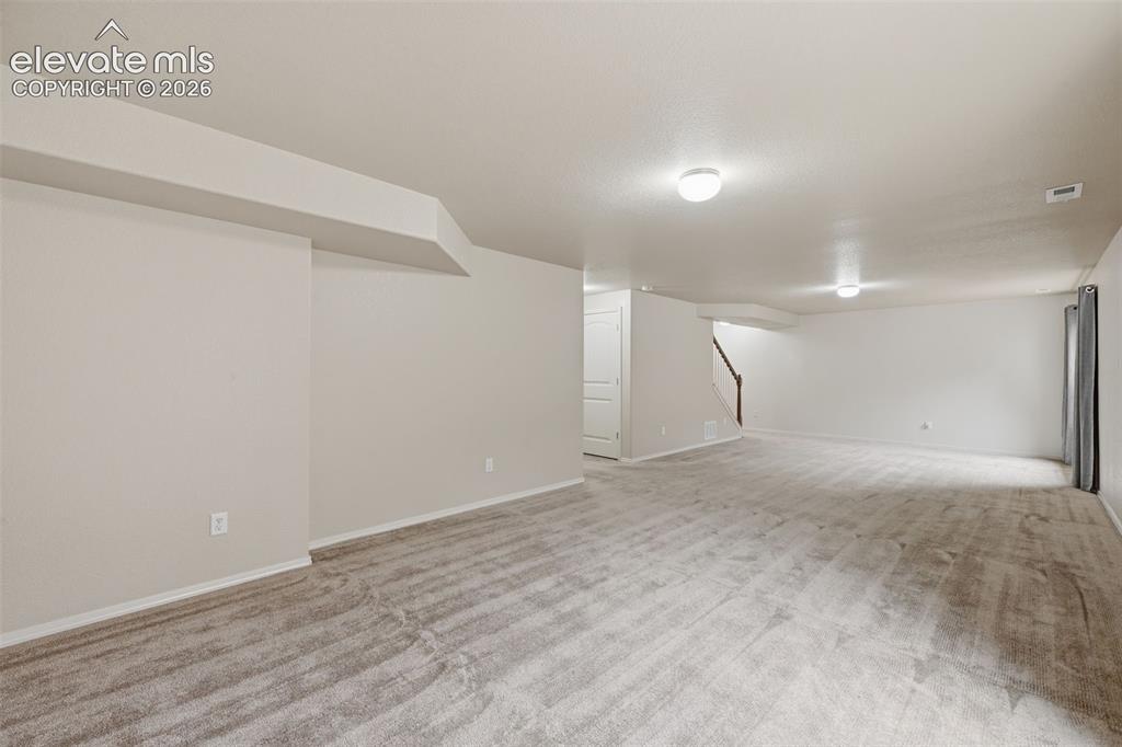 Image 24 of 37: Basement showing expansive space for Game room area at the bottom of the st
