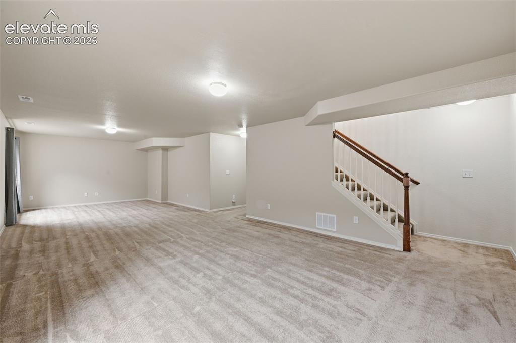Image 25 of 37: Family room area past the game room area great for movie nights and hanging