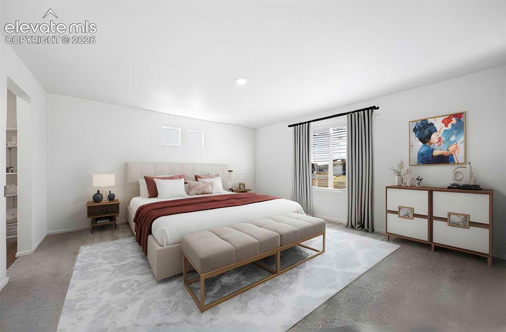 Image 11 of 15: Spacious bedroom featuring light-colored walls and mixed flooring with both