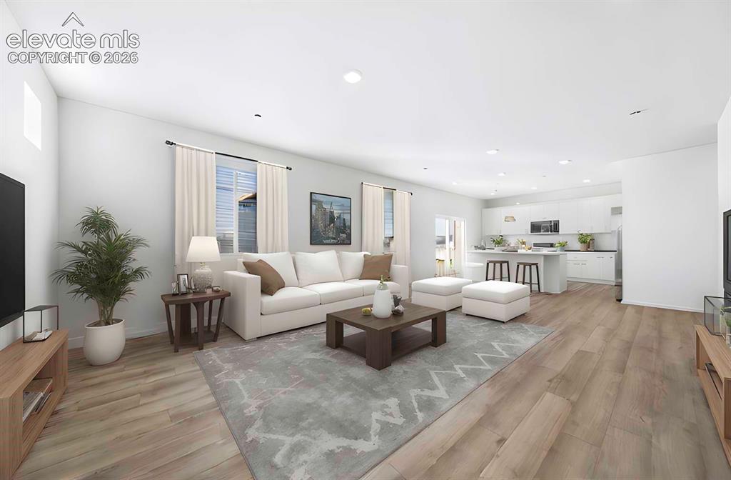 Image 5 of 15: Open-concept living space featuring wood-finish flooring, recessed lighting