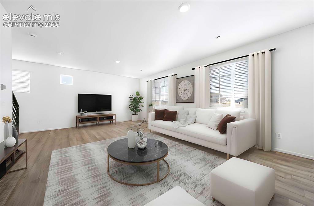 Image 6 of 15: Spacious living area featuring light wood-finish flooring, recessed lightin