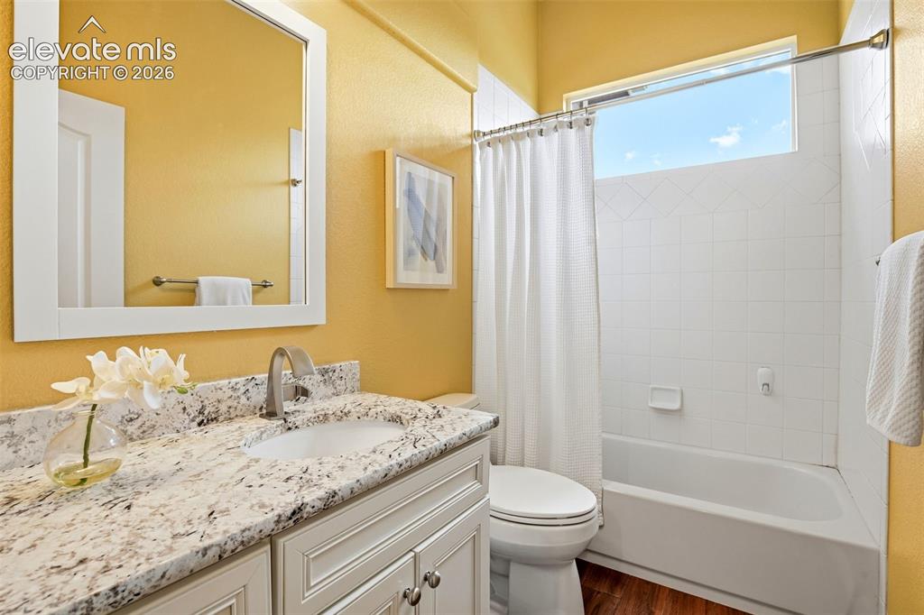 Image 14 of 41: One of three full baths updated with a beautiful wood look porcelain tile -