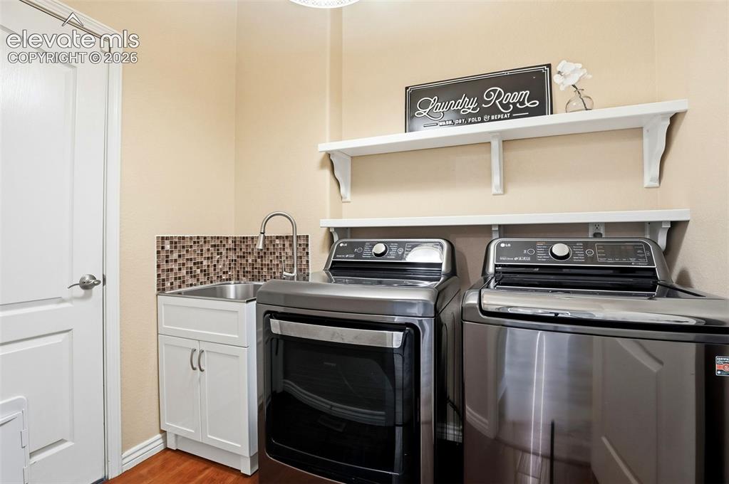 Image 15 of 41: Laundry room featuring front-load washer and dryer which are included, mosa