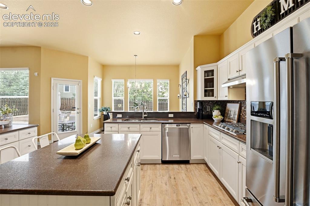 Image 16 of 41: Bright kitchen with an abundance of lower cabinets and long stretches of co