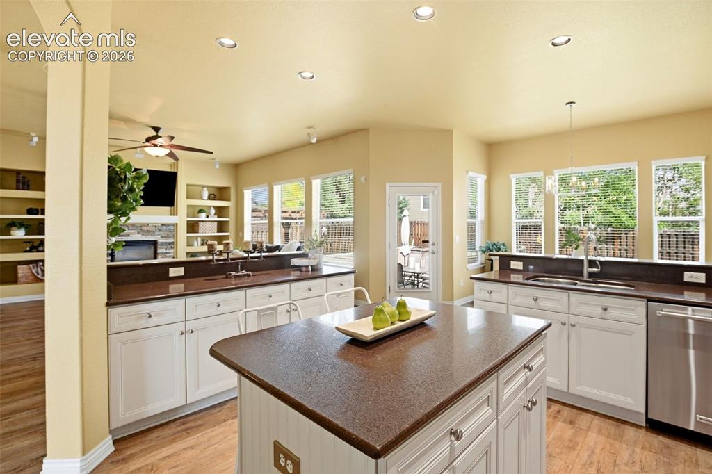 Image 19 of 41: Kitchen featuring an island with a built-in electrical outlet, white cabine