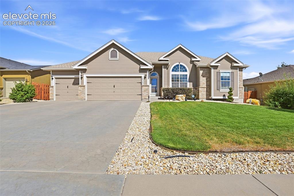 Image 2 of 41: Features neutral-toned siding, stone accents, oversized a multi-car drivewa