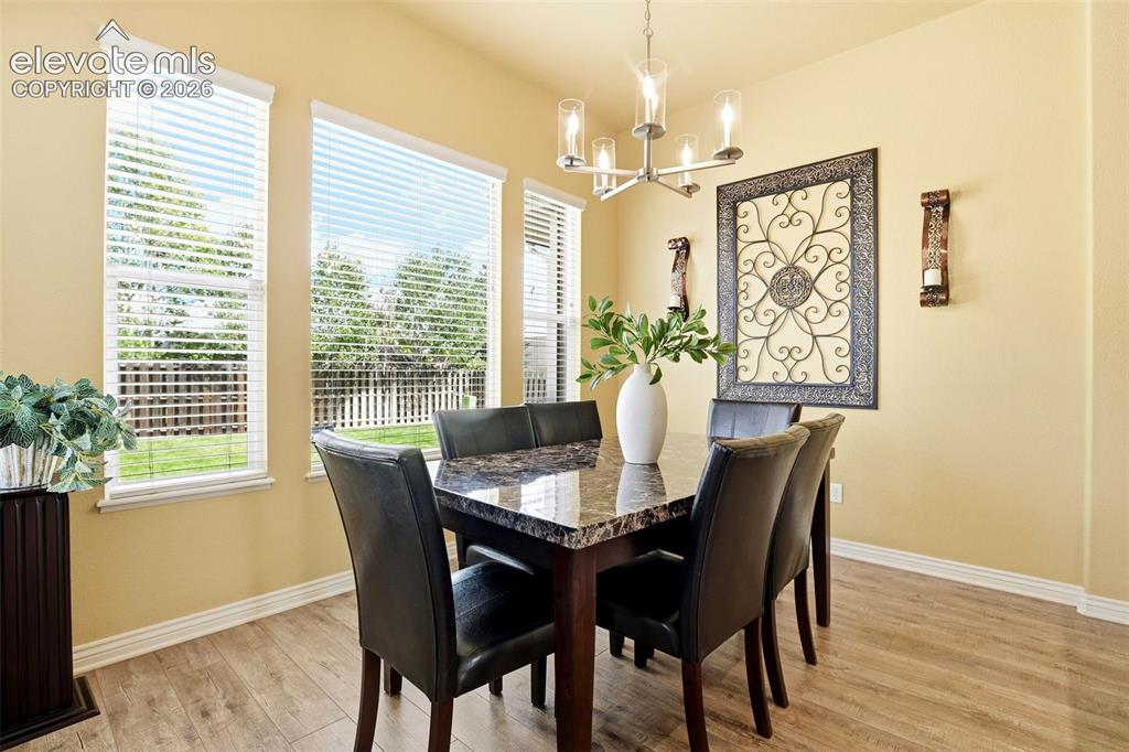 Image 21 of 41: Light filled dining area, backyard views and updated lighting.  The updated