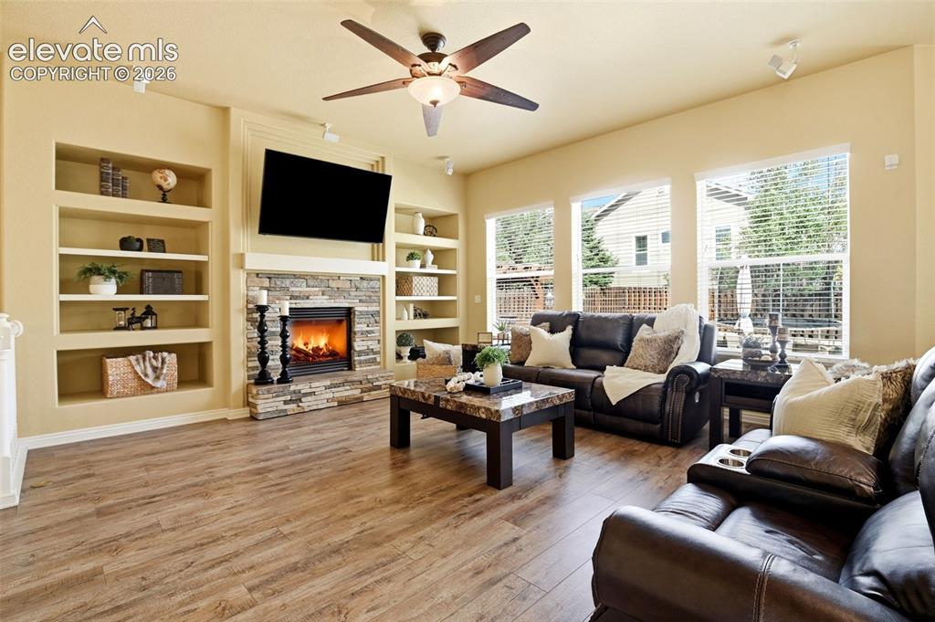 Image 23 of 41: Main living room with surround sound and speakers included, a fireplace, sh