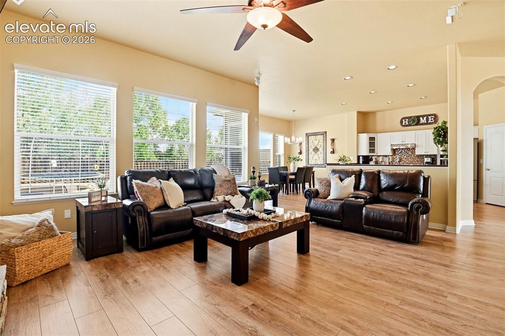 Image 25 of 41: Spacious common area featuring wood-finish flooring, recessed lighting, mul