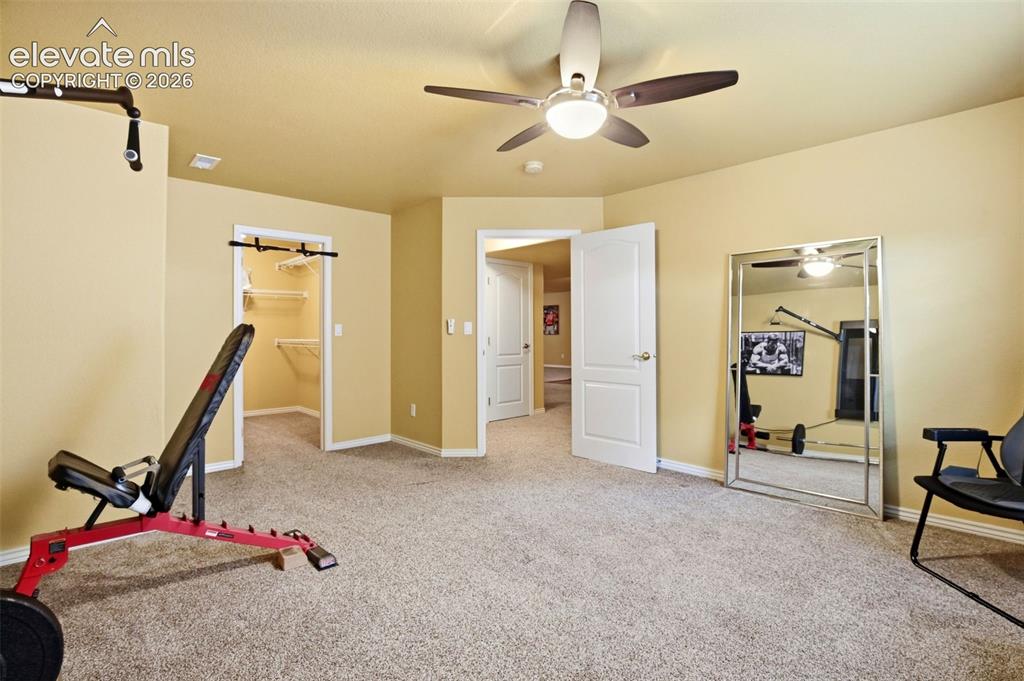Image 31 of 41: Oversized basement bedroom with walk-in closet.  Shown here as a work-out s